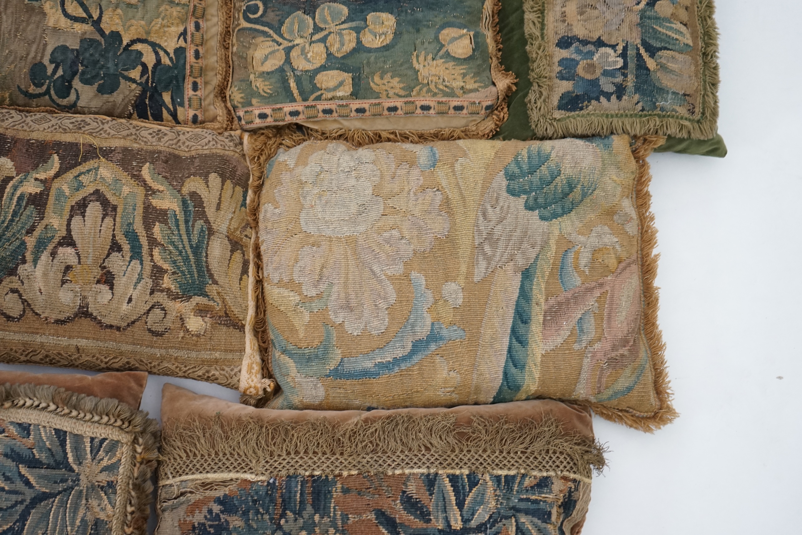 A four pairs of tapestry cushions and a similar single cushion